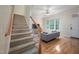 View of living room and staircase with hardwood floors and natural lighting at 1508 W Markham Ave, Durham, NC 27705