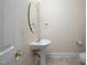 Cozy powder room features a pedestal sink, neutral tones, and tile flooring for a clean and functional space at 1508 W Markham Ave, Durham, NC 27705