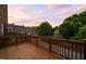 Beautiful wooden deck in a residential area provides an outdoor living space with neighborhood views and stunning twilight skies at 1508 W Markham Ave, Durham, NC 27705