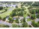 Aerial view of the home and neighborhood featuring mature trees, a nearby golf course and pond at 1605 Hunting Ridge Rd, Raleigh, NC 27615