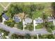 Overhead view of the home, landscaping, nearby golf course, and mature trees at 1605 Hunting Ridge Rd, Raleigh, NC 27615