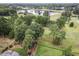 Stunning aerial view showcasing the lush golf course community and serene pond at 1605 Hunting Ridge Rd, Raleigh, NC 27615