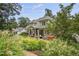 Expansive backyard features a covered patio and lush landscaping for outdoor enjoyment at 1605 Hunting Ridge Rd, Raleigh, NC 27615