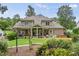 Lush backyard with a covered patio, a manicured lawn, and mature landscaping at 1605 Hunting Ridge Rd, Raleigh, NC 27615