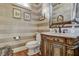 Stylish powder room with a marble vanity and ornate mirror at 1605 Hunting Ridge Rd, Raleigh, NC 27615