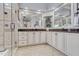 Luxurious bathroom featuring double sinks, a tiled shower, and ample counter space at 1605 Hunting Ridge Rd, Raleigh, NC 27615