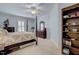 Cozy bedroom with a four-poster bed, ceiling fan, and classic furnishings at 1605 Hunting Ridge Rd, Raleigh, NC 27615