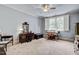 Bedroom with a ceiling fan, large window with shutters, and elegant furnishings at 1605 Hunting Ridge Rd, Raleigh, NC 27615