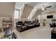 Spacious bonus room with a media center, ceiling fan, and a large window for natural light at 1605 Hunting Ridge Rd, Raleigh, NC 27615