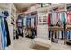 Walk-in closet with custom shelving, hanging racks, and a comfortable seating area at 1605 Hunting Ridge Rd, Raleigh, NC 27615