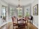 Elegant dining room with natural light from bay windows and hardwood flooring at 1605 Hunting Ridge Rd, Raleigh, NC 27615