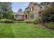 Charming two-story home featuring a stone facade and beautifully landscaped front yard at 1605 Hunting Ridge Rd, Raleigh, NC 27615