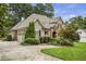 Beautiful home featuring brick and stone exterior and a spacious driveway at 1605 Hunting Ridge Rd, Raleigh, NC 27615
