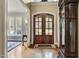 Grand foyer with hardwood floors, arched entryways, and a statement grandfather clock at 1605 Hunting Ridge Rd, Raleigh, NC 27615