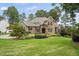Stunning stone-and-brick home with manicured lawn and mature landscaping at 1605 Hunting Ridge Rd, Raleigh, NC 27615