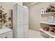 Functional laundry room with storage cabinets, shelving, and modern appliances at 1605 Hunting Ridge Rd, Raleigh, NC 27615