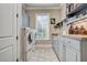Well-organized laundry room with a sink, counter space, and washer/dryer at 1605 Hunting Ridge Rd, Raleigh, NC 27615