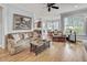 Cozy living room featuring hardwood floors and a large window at 1605 Hunting Ridge Rd, Raleigh, NC 27615