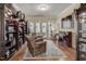 Inviting sitting room with a built-in bookshelf, piano, and french doors to the exterior at 1605 Hunting Ridge Rd, Raleigh, NC 27615