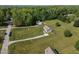 Expansive property featuring multiple homes and generous green space, set amidst a lush treeline at 164 Tillburg Ln, Hurdle Mills, NC 27541