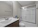 Clean bathroom featuring a combination tub and shower with clear glass sliding doors at 164 Tillburg Ln, Hurdle Mills, NC 27541