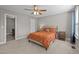 Bedroom with ceiling fan, plush carpet, and views of an ensuite bathroom at 164 Tillburg Ln, Hurdle Mills, NC 27541
