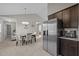 Dining room with modern chandelier, neutral walls, and stainless refrigerator at 164 Tillburg Ln, Hurdle Mills, NC 27541