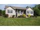 Charming home featuring neutral siding, black shutters, landscaping, and a welcoming porch at 164 Tillburg Ln, Hurdle Mills, NC 27541