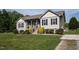Charming home with well-manicured lawn, flower boxes, and a welcoming front porch at 164 Tillburg Ln, Hurdle Mills, NC 27541