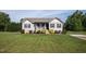 Charming single-story home with well-maintained lawn, black shutters, and a concrete driveway at 164 Tillburg Ln, Hurdle Mills, NC 27541
