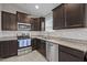 Modern kitchen features stainless steel appliances, granite countertops, and ample cabinet space at 164 Tillburg Ln, Hurdle Mills, NC 27541