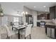 Open concept dining area with view to the kitchen, featuring stainless steel appliances at 164 Tillburg Ln, Hurdle Mills, NC 27541