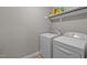 Laundry room featuring a washing machine and dryer with storage shelves at 164 Tillburg Ln, Hurdle Mills, NC 27541