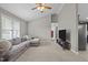 Spacious living room with a comfortable gray sectional sofa, ceiling fan, and a TV stand at 164 Tillburg Ln, Hurdle Mills, NC 27541