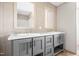 This bathroom boasts dual sinks set in a gray vanity, paired with wooden-framed mirrors and stylish wall tiling at 17 Star Dust Ln, Selma, NC 27576