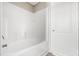 The bathroom features a sleek white tub/shower combination and a paneled door for a clean and functional design at 17 Star Dust Ln, Selma, NC 27576