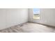 This bedroom has wood-look floors and a window that provides a view of the neighborhood at 17 Star Dust Ln, Selma, NC 27576