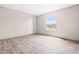 The bright bedroom features wood-look flooring and a large window with a peaceful neighborhood view at 17 Star Dust Ln, Selma, NC 27576