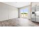 Bright dining area with sliding glass doors to the deck, next to a stainless-steel refrigerator at 17 Star Dust Ln, Selma, NC 27576
