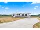 Charming home with covered front porch, manicured lawn, and long driveway at 17 Star Dust Ln, Selma, NC 27576