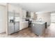 Bright kitchen with stainless steel refrigerator, center island, and stylish gray backsplash at 17 Star Dust Ln, Selma, NC 27576
