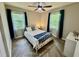 Cozy bedroom with natural light, ceiling fan, and stylish herringbone floors at 1708 Sundial Pl, Raleigh, NC 27610