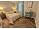 Cozy bedroom with a charming vanity, herringbone floors, and bright, patterned curtains for a comfortable and stylish retreat at 1708 Sundial Pl, Raleigh, NC 27610