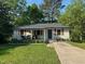 Charming single-story home features a covered porch, well-maintained lawn, and inviting curb appeal at 1708 Sundial Pl, Raleigh, NC 27610