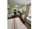 Modern kitchen with stainless steel appliances, white cabinets, and herringbone floors at 1708 Sundial Pl, Raleigh, NC 27610