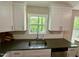 Updated kitchen featuring modern fixtures, granite countertops, and lots of natural light at 1708 Sundial Pl, Raleigh, NC 27610