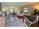 Open-concept living space boasts stylish herringbone floors and abundant natural light at 1708 Sundial Pl, Raleigh, NC 27610