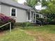 Charming home featuring a covered entryway, traditional siding, and lush landscaping with flowering shrubs at 1812 House Ave, Durham, NC 27707