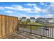 Scenic backyard features a wooden deck with a railing, a lush lawn, and a view of neighboring houses at 1844 Austin Ridge Pkwy, Wake Forest, NC 27587