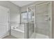 Elegant bathroom with a soaking tub, a decorative window, and glass shower, creating a spa-like experience at 1844 Austin Ridge Pkwy, Wake Forest, NC 27587